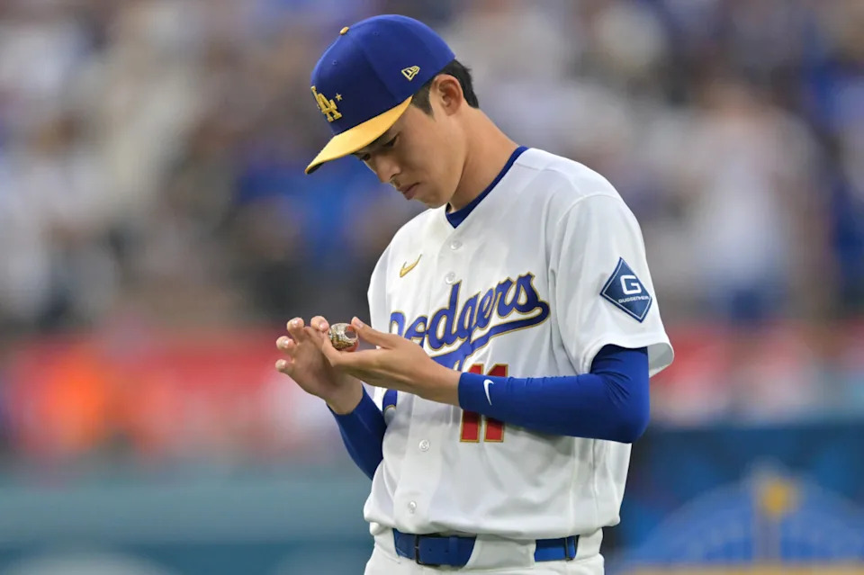 Mar 27, 2026; Los Angeles, California, USA; Los Angeles Dodgers pitcher Roki Sasaki (11) holds his ring during the World Series ring ceremony before the game against the Arizona Diamondbacks at Dodger Stadium. Mandatory Credit: Jayne Kamin-Oncea-Imagn Images