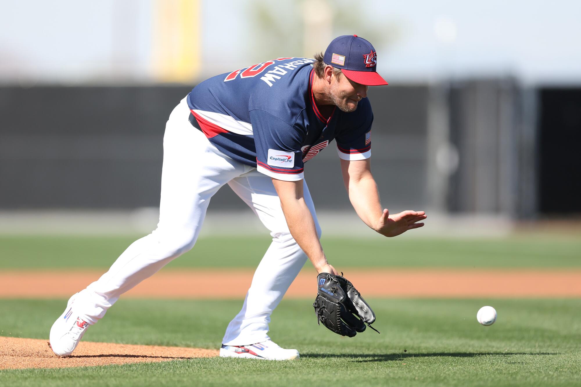 Former Dodgers pitcher Clayton Kershaw fields a ground ball during a workout at Papago Park Sports Complex on Monday.