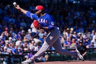 Texas Rangers pitcher Kumar Rocker delivers during the first inning of a spring training...