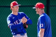 Texas Rangers pitcher Jacob Latz talks with  pitching coach Jordan Tiegs in the bullpen...