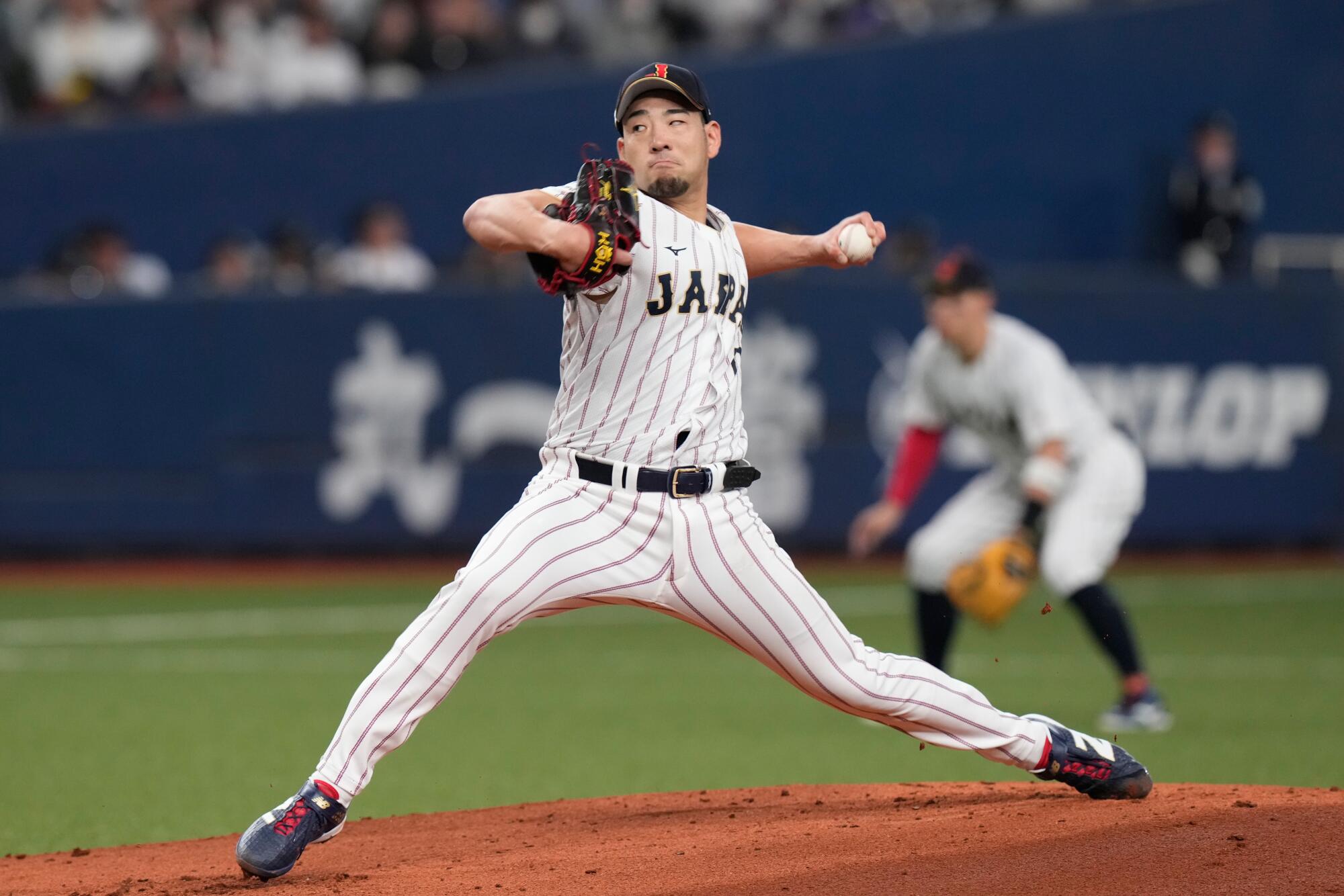 Japan's Yusei Kikuchi throws a pitch during an exhibition game against the Orix Buffaloes Monday in Osaka, Japan. 