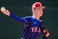 Texas Rangers minor league pitcher Jacob Johnson throws in the bullpen during a spring...
