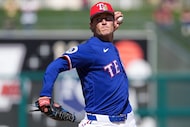 Texas Rangers pitcher Jacob Latz delivers during the first inning of a spring training game...
