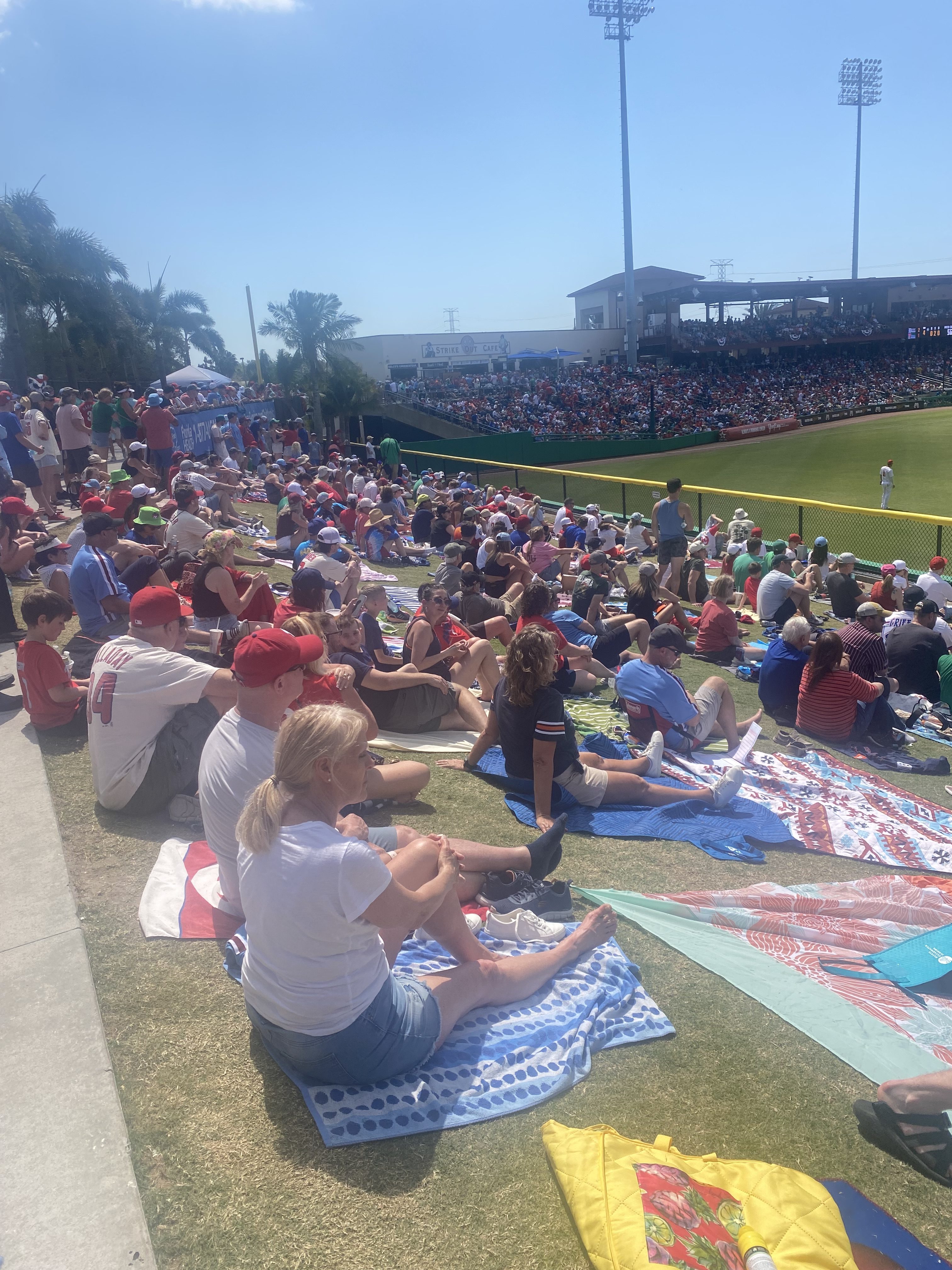 Fans on beach towels and blankets fill the rightfield berm...