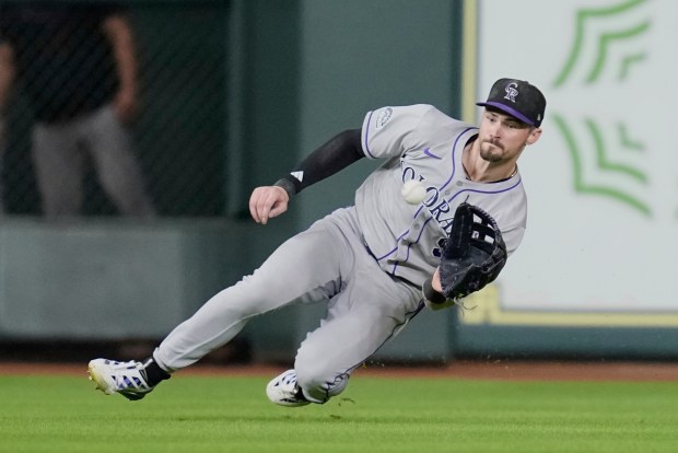 Colorado Rockies center fielder Brenton Doyle catches a line drive by Houston Astros' Victor Caratini during the eighth inning of a baseball game Tuesday, Aug. 26, 2025, in Houston. (AP Photo/David J. Phillip)