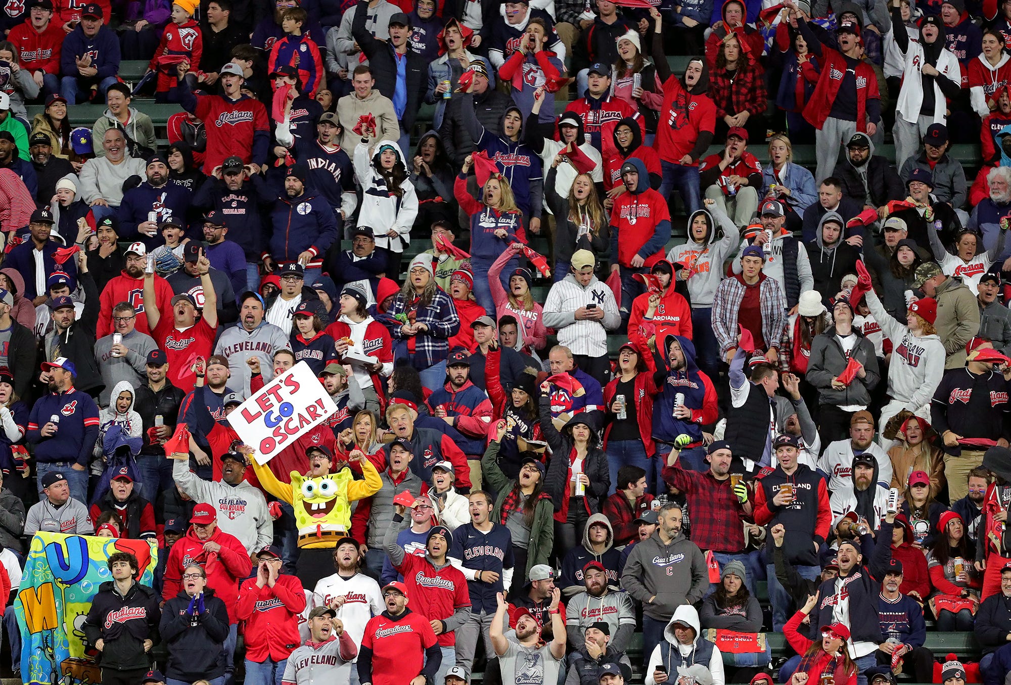 Cleveland Guardians fans, including one dressed as SpongeBob cheer for Cleveland Guardians right fielder Oscar Gonzalez (39) during the second inning of Game 4 of an American League Division baseball series at Progressive Field, Sunday, Oct. 16, 2022, in Cleveland, Ohio. Alds Game 4 7