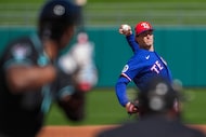 Texas Rangers pitcher Jacob Latz delivers during the second inning of a spring training game...