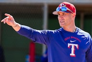 Texas Rangers manager Skip Schumaker directs a drill during a spring training workout at the...