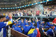 The Venezuela team celebrates after defeating Italy at a World Baseball Classic semifinal...
