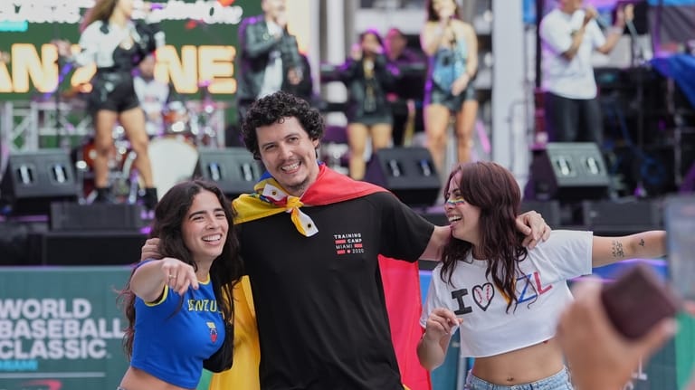 Venezuela fans pose for photos before the championship game of...