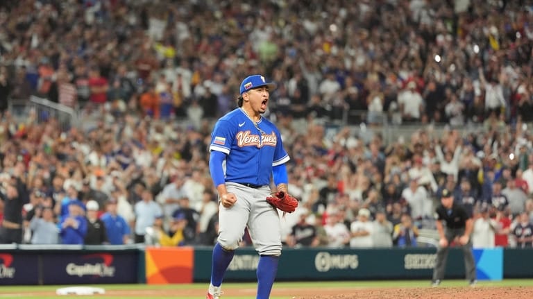 Venezuela pitcher Daniel Palencia celebrates after the team defeated the...