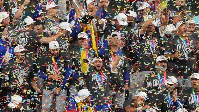 The Venezuela team celebrates after defeating the United States in...
