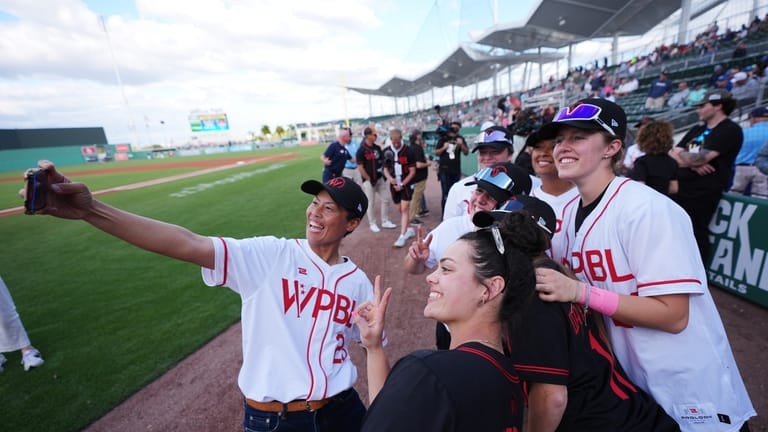 Women's Pro Baseball League players including Ayami Sato, left, take...