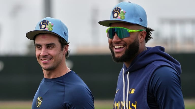 Milwaukee Brewers' Jackson Chourio talks to Sal Frelick during a...