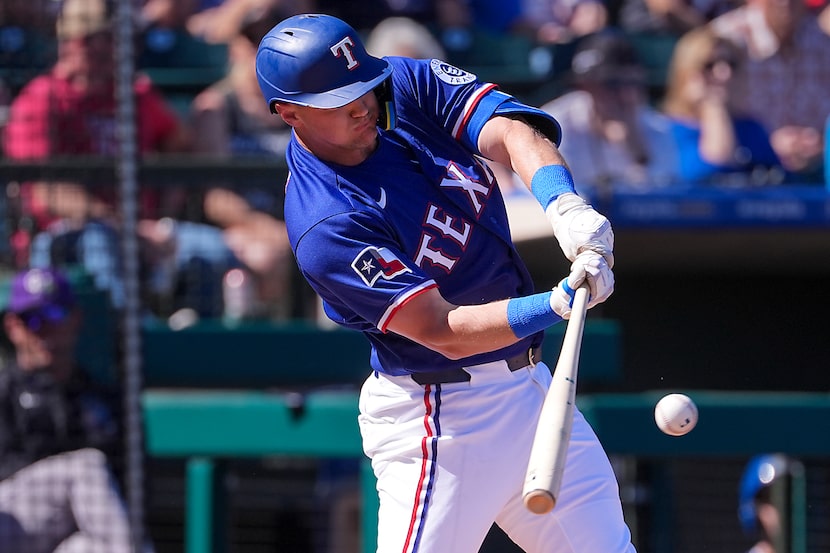 Texas Rangers third baseman Josh Jung singles during the second inning of a spring training...