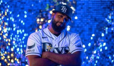 A baseball player modeling a jersey