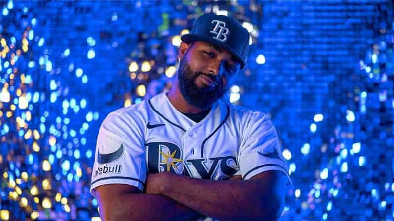 A baseball player modeling a jersey