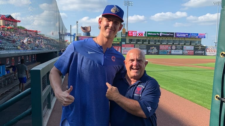 Ward Melville baseball coach Lou Petrucci, right, with one of...