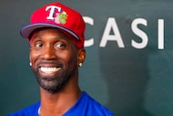 Texas Rangers outfielder Andrew McCutchen smiles while talking with reporters before an...
