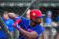 Texas Rangers outfielder Andrew McCutchen takes batting practice before an exhibition...