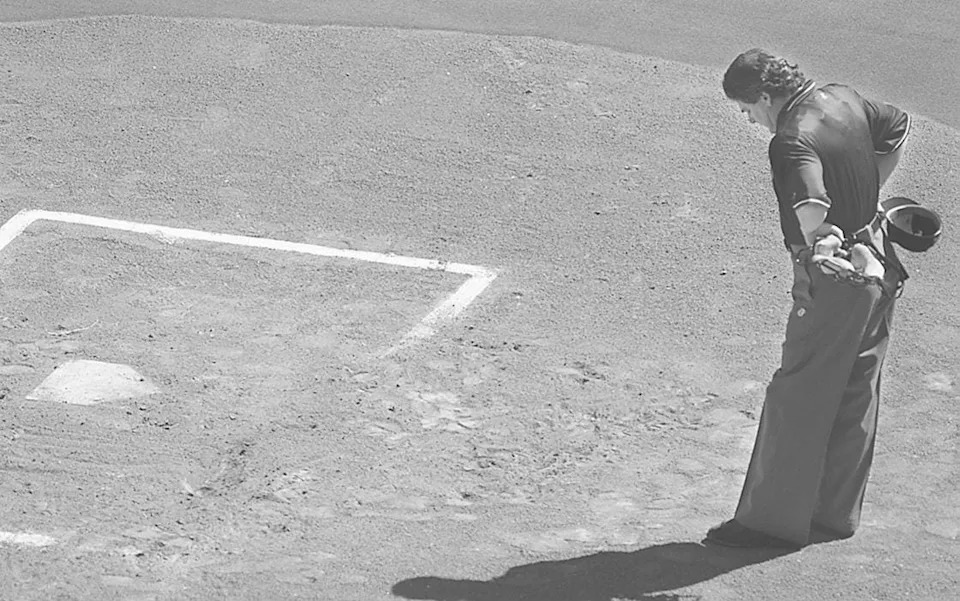 April 2, 1996: Umpire Jerry Crawford pauses behind home plate as he awaits the Reds batters in the middle of the first inning at Riverfront Stadium.