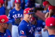 Texas Rangers outfielder Wyatt Langford laughs in the dugout before a spring training game...