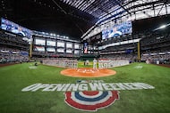 Players stand as Randall King sings the national anthem before an opening day baseball game...