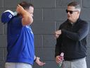 Toronto Blue Jays manager John Schneider, left, talks with Blue Jays general manager Ross Atkins, right, as players work out during spring training in Dunedin Fla., on Friday, February 14, 2025.