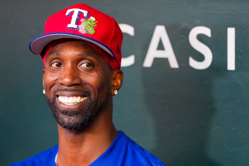 Texas Rangers outfielder Andrew McCutchen smiles while talking with reporters before an...