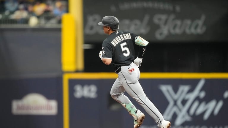 Chicago White Sox' Munetaka Murakami runs the bases after hitting...