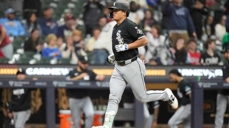 Chicago White Sox' Munetaka Murakami runs the bases after hitting...