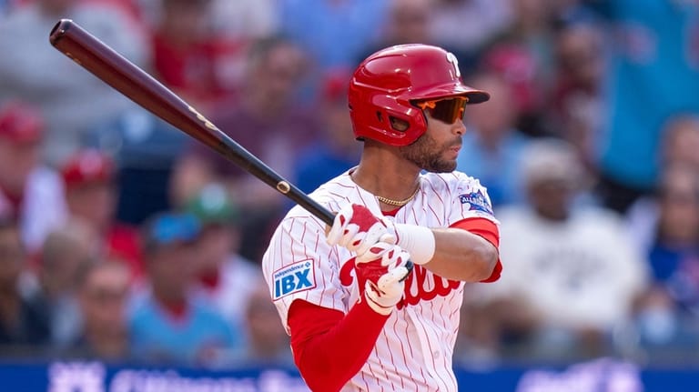 Philadelphia Phillies' Justin Crawford hits a single for his first...