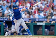 Texas Rangers' Jake Burger hits a two-run home run during the ninth inning of an opening-day...