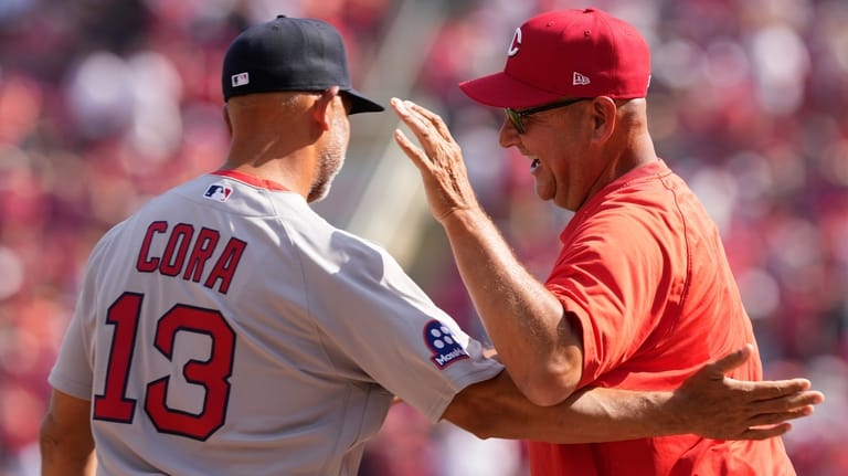 Boston Red Sox manager Alex Cora, left, Cincinnati Reds manager...