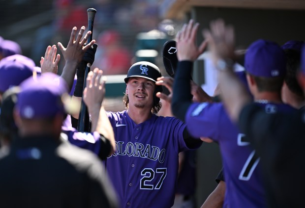 Outfielder Jordan Beck celebrates with teammates in the dugout after scoring the first run of a spring training game at Surprise Stadium in Surprise, Arizona on Feb. 22, 2026. The Colorado Rockies took on the Texas Rangers. (Photo by RJ Sangosti/The Denver Post)