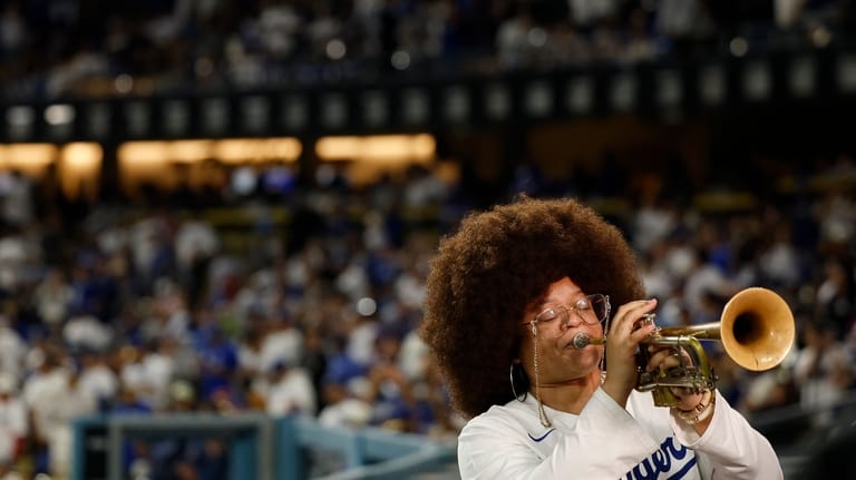 Tatiana Tate plays the trumpet as Los Angeles Dodgers relief...