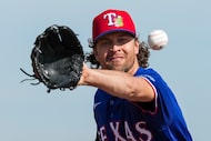 Texas Rangers pitcher Jacob Degrom participates in a fielding drill during a spring training...