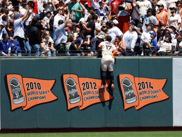 San Francisco Giants' Heliot Ramos (17) can only watch as a ball hit by Los Angeles Dodgers' Miguel Rojas (72) leaves the park for a solo home run in the fifth inning at Oracle Park in San Francisco, Calif., on Sunday, July 13, 2025. (Nhat V. Meyer/Bay Area News Group)