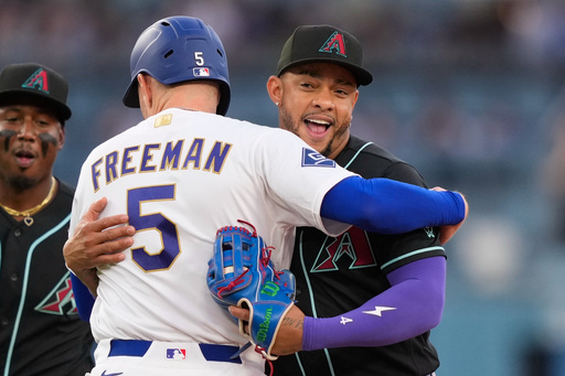 Arizona Diamondbacks second baseman Ketel Marte, right, hugs Los Angeles Dodgers