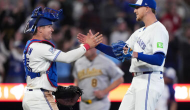 Toronto Blue Jays pitcher Jeff Hoffman (23) celebrates with teammate Toronto Blue Jays catcher Tyler Heineman, left, after defeating the Athletics during the ninth inning of an American League baseball game, in Toronto, Sunday, March 29, 2026. (Nathan Denette/The Canadian Press via AP)