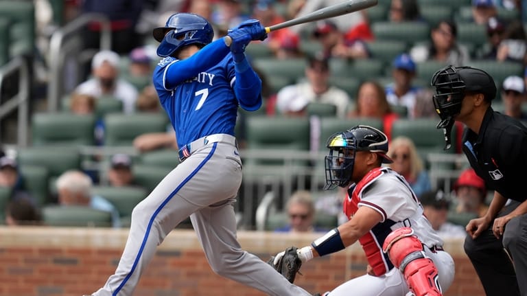 Kansas City Royals' Bobby Witt Jr. (7) hits an RBI-single...