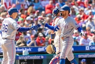 Texas Rangers' Brandon Nimmo, right, celebrates his two run homer with Wyatt Langford (36)...