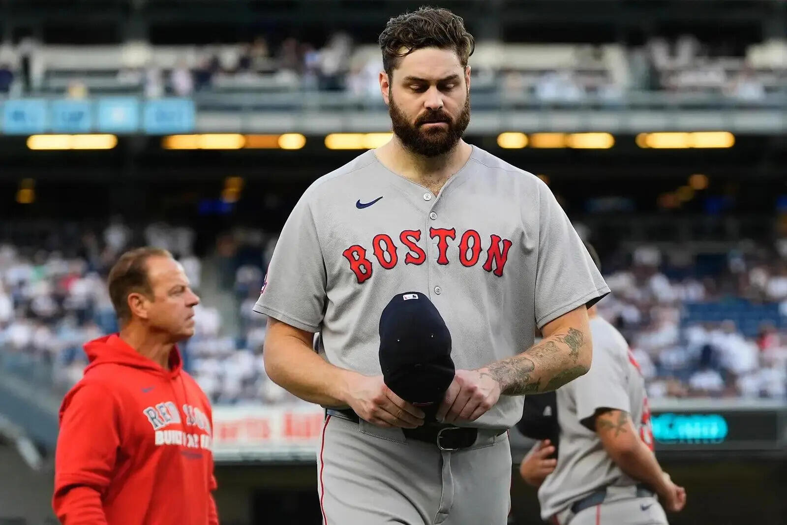 Boston Red Sox pitcher Lucas Giolito, left, walks off the field after player introductions before Game 1 of an American League wild-card baseball playoff series