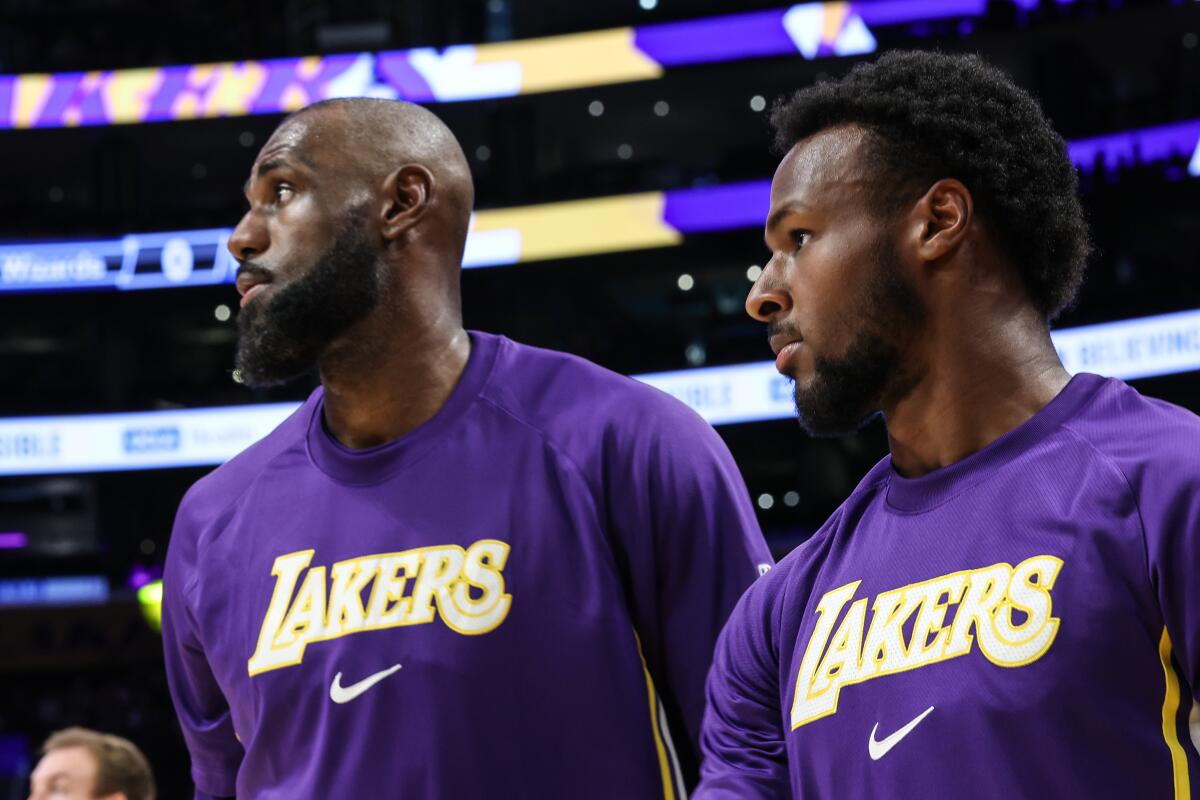 Lakers star LeBron James, left, stands next to his son and Lakers guard Bronny James at Crypto.com Arena.