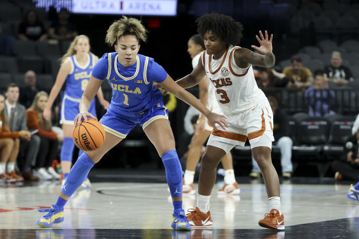 UCLA guard Kiki Rice dribbles under pressure from Texas guard Rori Harmon on Nov. 26 in Las Vegas.
