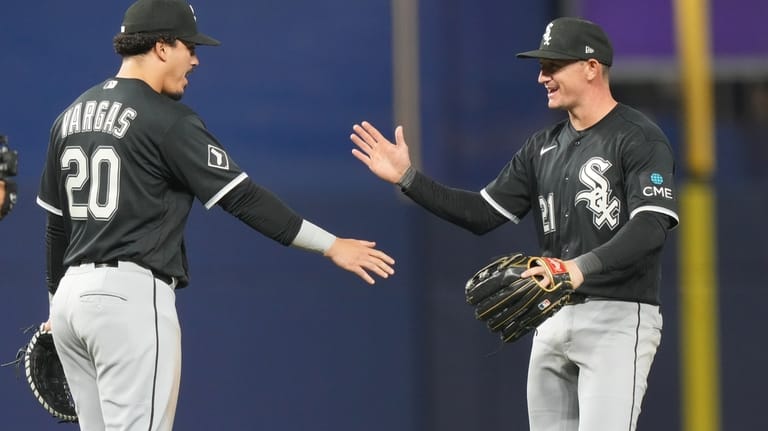 Chicago White Sox third baseman Miguel Vargas (20) and left...