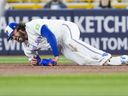 Cody Ponce #of the Toronto Blue Jays falls to the ground with an injury during the third inning in against the Colorado Rockies at the Rogers Centre on Monday. 

Getty Images)