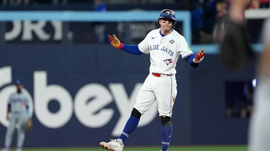 Clement shrugs his shoulders at second base in a white Blue Jays uniform during the World Serie