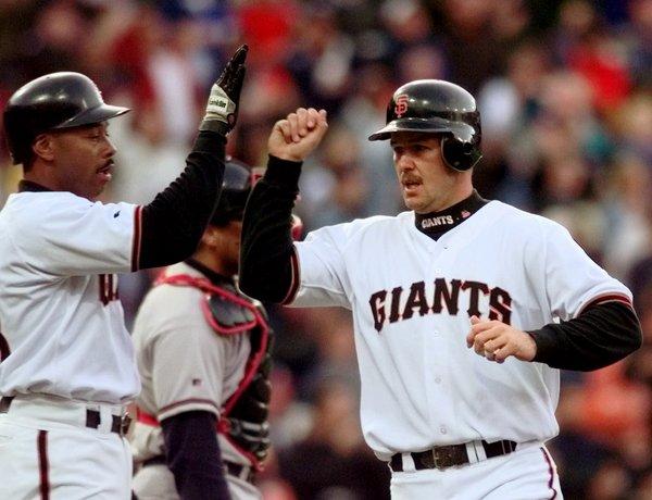 San Francisco Giants' Jeff Kent, right, is congratulated by teammate Ellis Burks after the pair scored on a three-run double by J.T. Snow during the Giants' six-run first inning against the Atlanta Braves Tuesday, May 11, 1999, in San Francisco. (AP Photo/Bob Galbraith) 