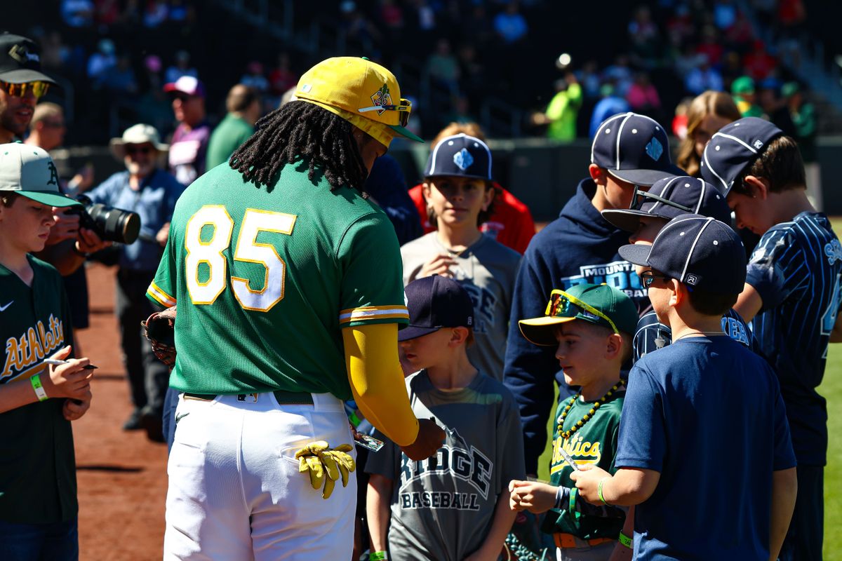 Athletics INF Joshua Kuroda-Grauer (85) signs baseballs for fans prior to an MLB Spring Training game against the Los Angeles Angels on Sunday March 8, 2026, in Las Vegas, Nevada. 